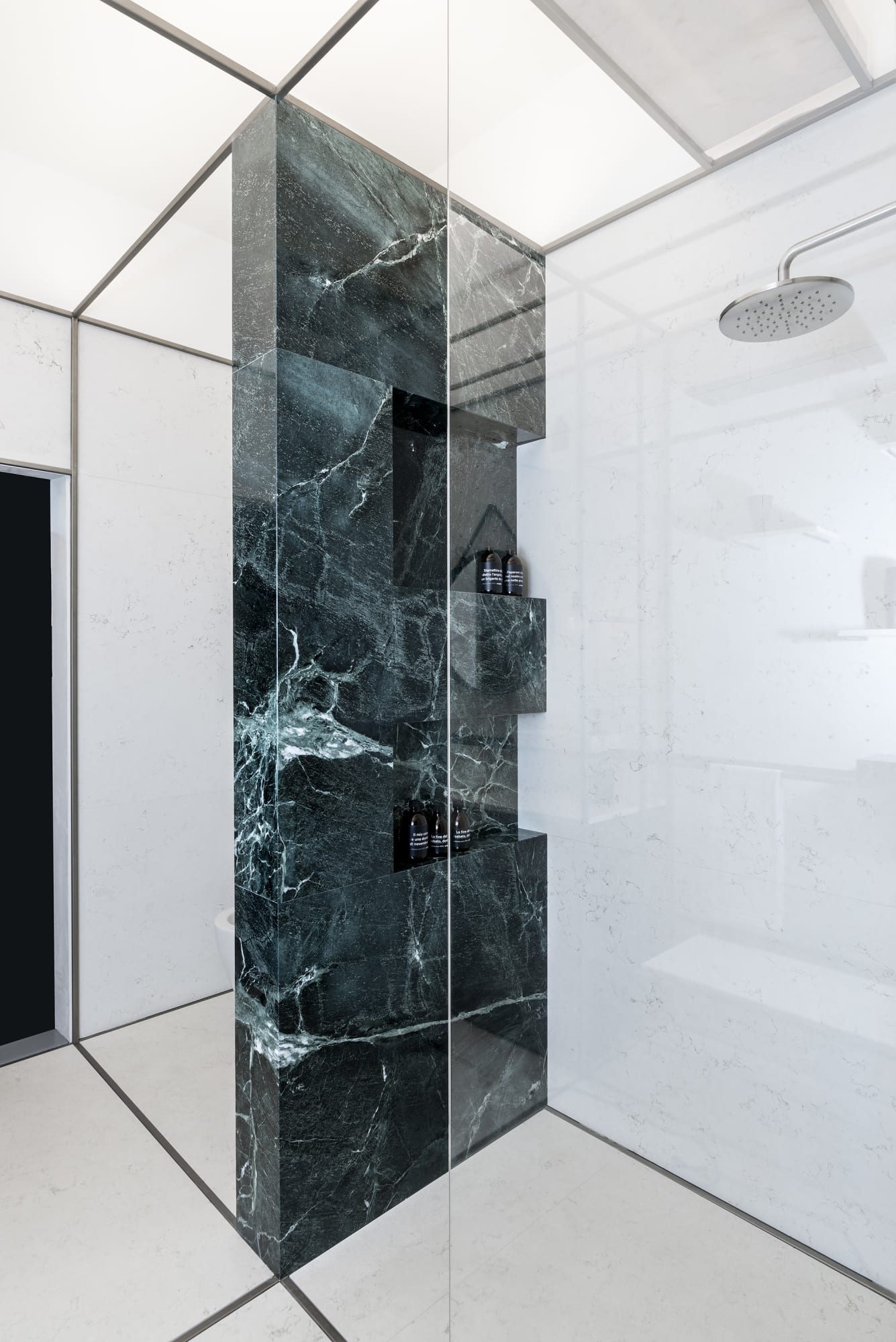 Bagno minimal, doccia con parete attrezzata in marmo verde